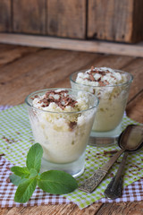 Milk ice cream from green tea sprinkled with black chocolate in a glass on a wooden background. Mint Sorbet. Place for text