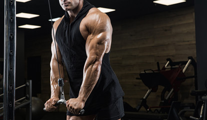Brutal strong athletic men pumping up muscles workout bodybuilding concept background - muscular bodybuilder handsome men doing exercises in gym - obrazy, fototapety, plakaty