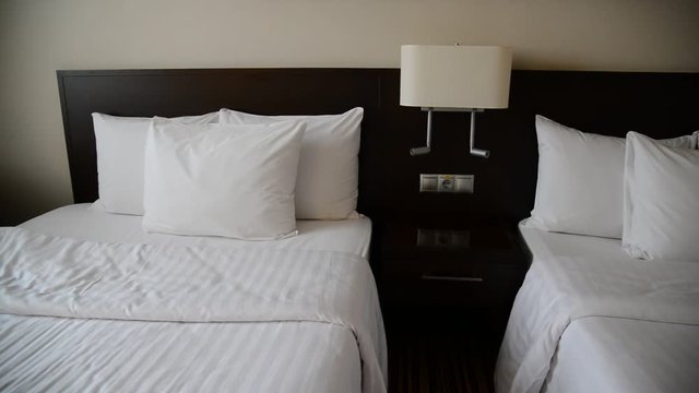 Small hotel room with two beds