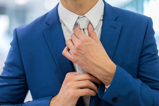 Portrait of a businessman adjusting his tie