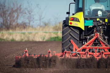 Kissenbezug Landwirt im Traktor bereitet Land mit Saatbettkultivator vor © zorandim75