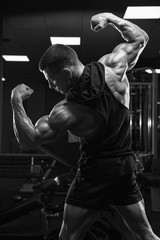 Fototapeta na wymiar Brutal strong athletic men pumping up muscles workout bodybuilding concept background - muscular bodybuilder handsome men doing exercises in gym