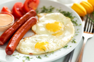 Sausages with fried eggs for breakfast