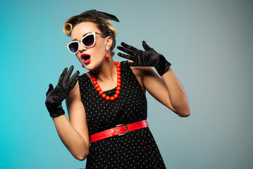 Portrait of beautiful young surprised woman, dressed in pin-up style.