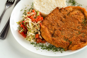 Austrian schnitzel with rice and cabbage salad