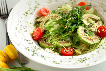 Healthy vegetarian salad with avocado and arugula