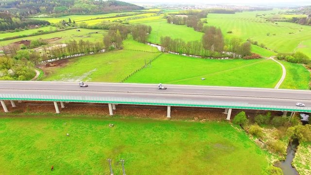 Aerial view of bridge over Radbuza River and green pastures. Highway D5 with traffic near Pilsen, Czech republic, Central Europe. Transportation and sustainable development concept. 