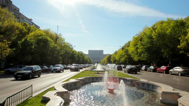 Beautiful Horizontal Panorama of the View to the Parliament Building in Bucharest, the Capital of Romania with Busy Street with Fountains