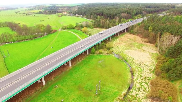 Aerial view of bridge over Radbuza River and green pastures. Highway D5 with traffic near Pilsen, Czech republic, Central Europe. Transportation and sustainable development concept. 