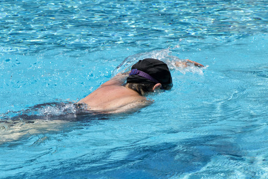 Woman swiiming in transparent water at SPA