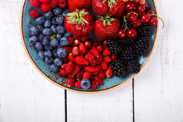 Various Fresh Summer Berries on a white Background.Food or Healthy diet concept.Super Food.Vegetarian.Buddha Bowl.Copy space for Text. selective focus.