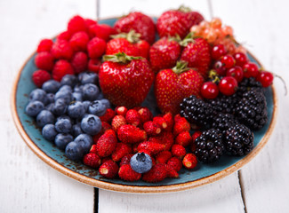 Various Fresh Summer Berries on a white Background.Food or Healthy diet concept.Super Food.Vegetarian.Buddha Bowl.Copy space for Text. selective focus.