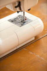 Sewing machine close up on aged wooden table