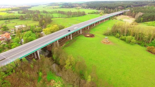 Aerial view of bridge over Radbuza River and green pastures. Highway D5 with traffic near Pilsen, Czech republic, Central Europe. Transportation and sustainable development concept. 