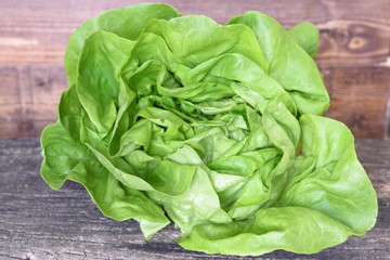 A beautiful lettuce salad on a wooden background.