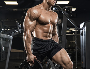 Brutal strong athletic men pumping up muscles workout bodybuilding concept background - muscular bodybuilder handsome men doing exercises in gym - obrazy, fototapety, plakaty