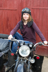 Photo of girl on a vintage motorbike in pilot cap