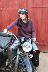 Fototapeta na wymiar Photo of girl on a vintage motorbike in pilot cap