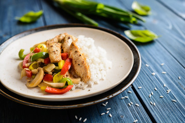 Fried chicken breasts pieces served with steamed vegetable and rice