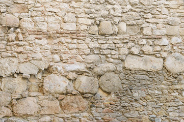 Old beige stone wall background texture