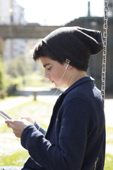 child with the mobile phone in the playground outdoor