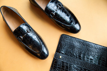men's black shoes on a yellow background