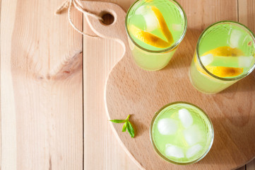 Lemonade glasses with lemon, mint and ice. Top view with copy space