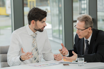 Stylish businessmen working in office