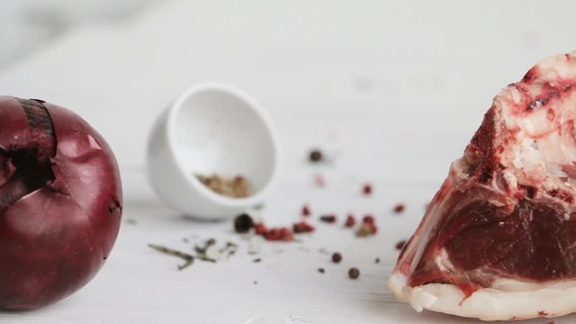 Saddle of mutton - raw red meat - with vegetables. herbs and spices on wooden table. Slow pan.