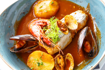 Fish stew with seafood in tomato sauce or bribes.