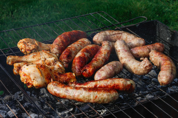 Cook out. Sausages and chicken on grill