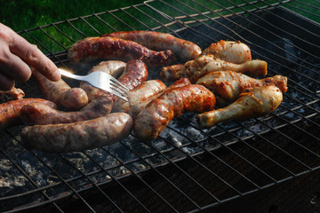 Cook out. Sausages and chicken on grill