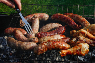 Cook out. Sausages and chicken on grill