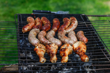 Cook out. Sausages and chicken on grill