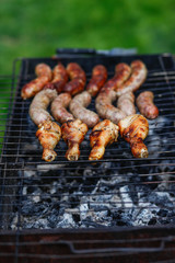 Cook out. Sausages and chicken on grill