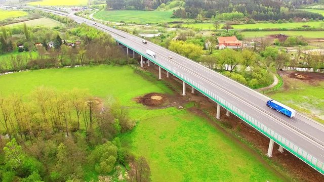 Aerial view of bridge over Radbuza River and green pastures. Highway D5 with traffic near Pilsen, Czech republic, Central Europe. Transportation and sustainable development concept. 