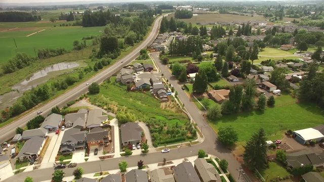 Aerial footage pans to the left over a suburban neighborhood 