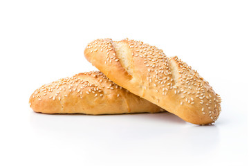 Loaves of white bread with sesame seeds over white