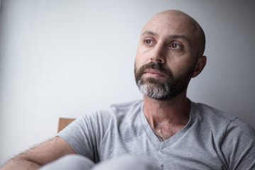 Mid forties depressed man in bed at home