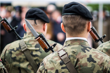 Polish soldiers armed with rifles during the ceremony