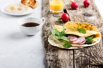 Brunch table. Homemade omelette spinach tacos on rustic wooden table, Mexican food