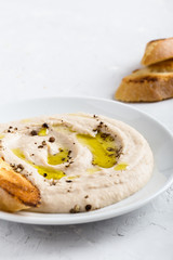 White bean dip on white plate