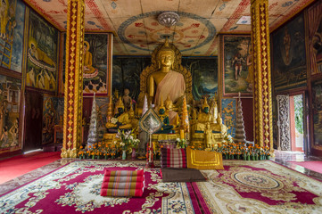 Fototapeta premium Gold Buddha statue inside the Wat Luang - buddhist temple in Pakse, Champasak province, Laos