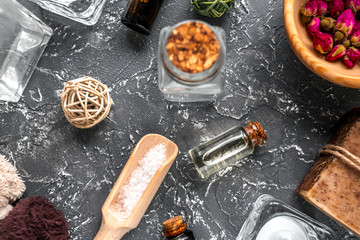 bathroom salt and natural soap for spa on dark background top view