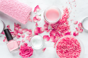 Obraz na płótnie Canvas Nail care spa set with rose polish, cream white background top view
