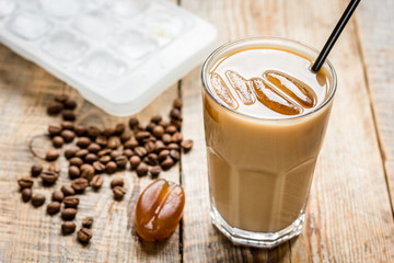 iced coffee with beans for cold summer drink on wooden background