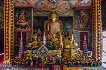 Fototapeta na wymiar Gold Buddha statue inside the Wat Luang - buddhist temple in Pakse, Champasak province, Laos