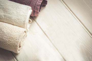 Towels over white wooden background. Spa products