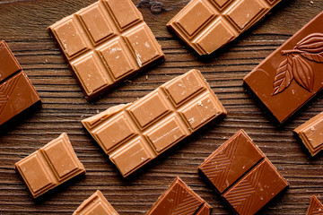 black chocolate pattern on wooden background top view