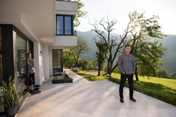 man in front of his luxury home villa